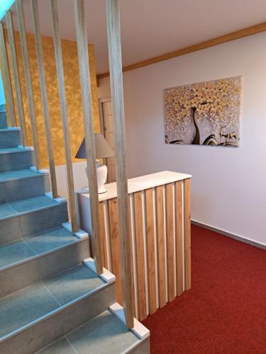 a room with stairs and a painting on the wall at In apartman in Nikšić