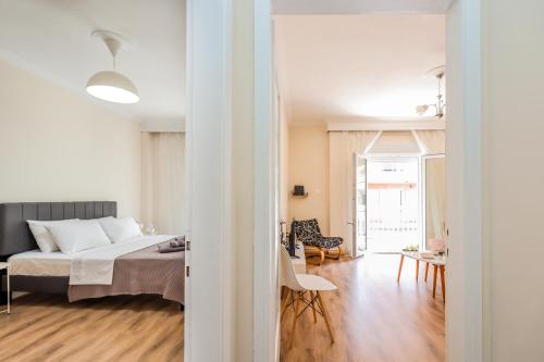 a bedroom with a bed and a living room at Grand Apartment Next to Center 3bd 110sqm in Thessaloniki