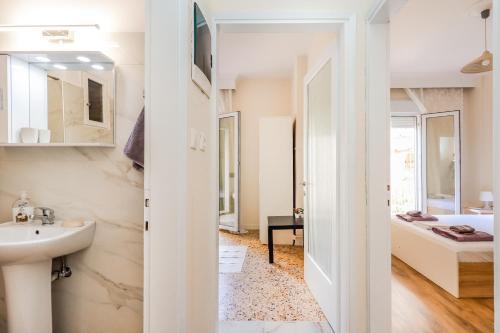 a bathroom with a sink and a mirror at Grand Apartment Next to Center 3bd 110sqm in Thessaloniki