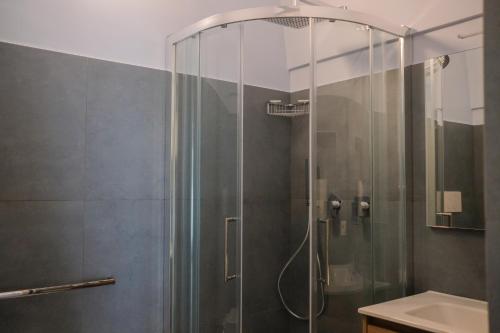 a shower with a glass door in a bathroom at Suite Polignani by STHEY in Monopoli