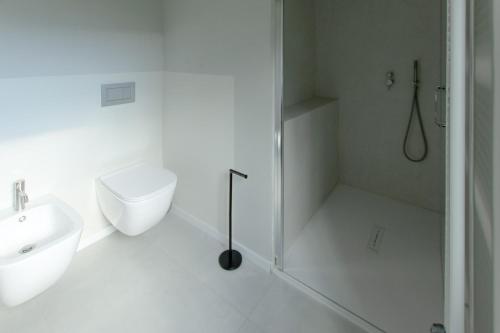a bathroom with a shower and a toilet and a sink at Style apartments VdA in Senin