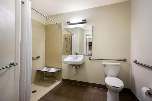 a bathroom with a toilet and a sink at Sonesta Simply Suites St Louis Earth City in Earth City