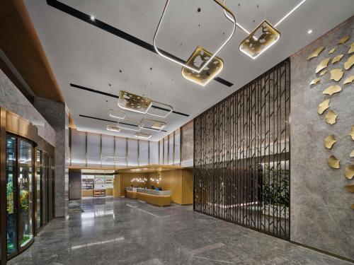 a lobby of a building with a large wall at Hilton Garden Inn Beijing Haidian Daoxiang Lake in Beijing