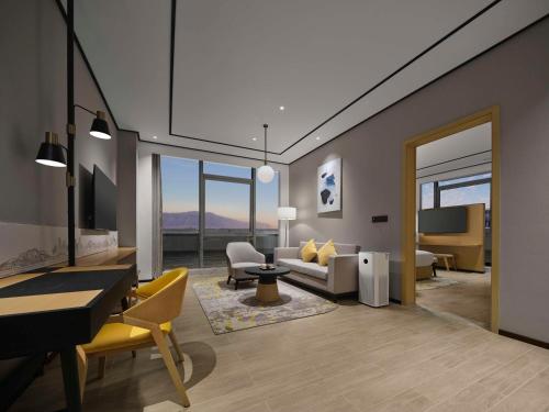 a living room with a couch and a table at Hilton Garden Inn Beijing Haidian Daoxiang Lake in Beijing