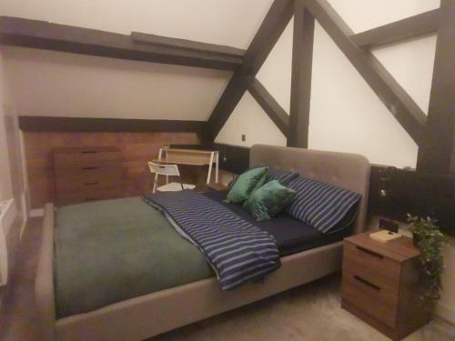 a bedroom with a large bed with a wooden frame at The Loft in Bradford