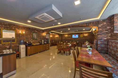 a restaurant with wooden tables and chairs and a bar at Aprilis Gold Hotel - Special Category in Istanbul