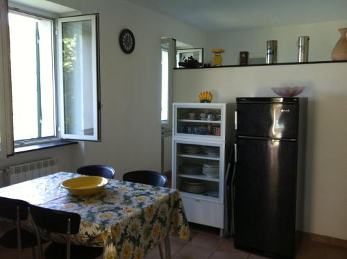 a kitchen with a table and a refrigerator at Dolcevia in Levanto