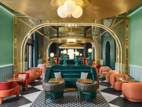 a salon with red chairs and a green couch at W Budapest in Budapest