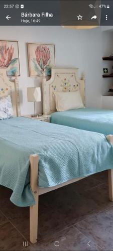 a bedroom with a bed with a blue blanket on it at Casa O Arco Alojamento Local in Marvão