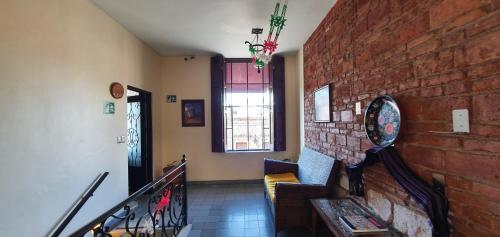 a room with a staircase with a brick wall at ROSA BARROCO in Morelia