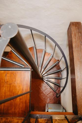 a metal spiral staircase in a room with wooden floors at Hotel Casa Pereyra in Oaxaca City