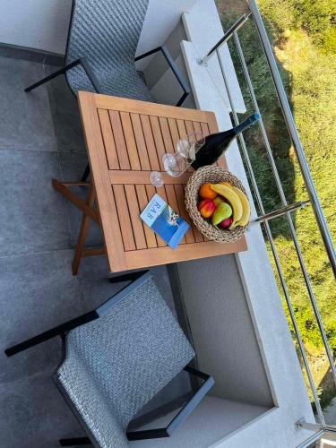 a bird sitting on a table with a basket of fruit at MEMORI bed&breakfast in Rab