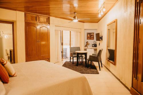 a bedroom with a bed and a table and chairs at Hotel Casa Pereyra in Oaxaca City