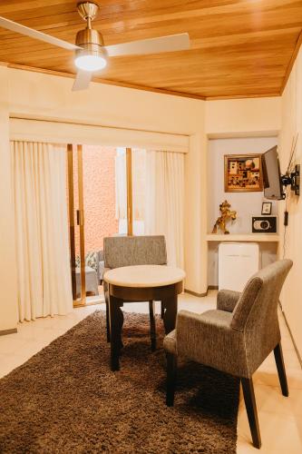 a living room with a table and two chairs at Hotel Casa Pereyra in Oaxaca City
