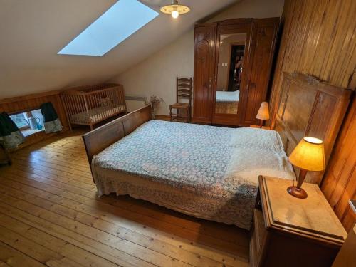 a bedroom with a bed and a skylight at Maison de charme en pierres, proche de la nature, idéale pour balades, proche Épinal - FR-1-589-73 in Girancourt