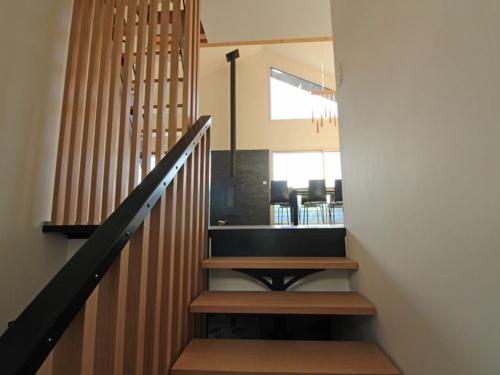 a stairway with wooden steps and a table at Chalet à La Bresse avec cheminée et garage - FR-1-589-385 in La Bresse