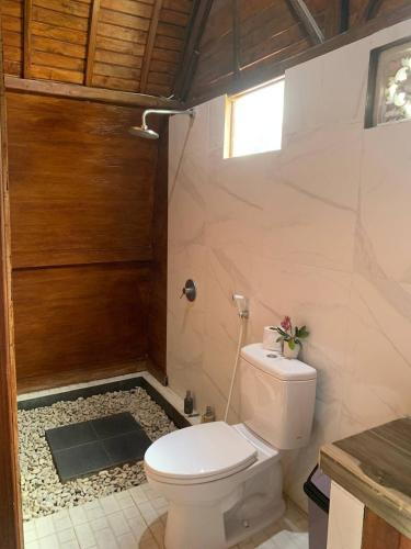 a bathroom with a toilet and a shower at Volcano Valley in Kintamani