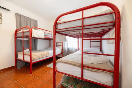 a room with two bunk beds in a room at R&V Combate Beach House 1 with Pool in Cabo Rojo