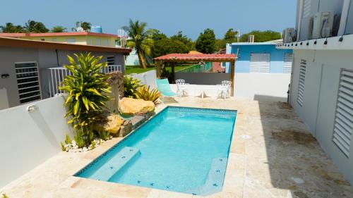 a swimming pool on the back of a house at R&V Combate Beach House 1 with Pool in Cabo Rojo