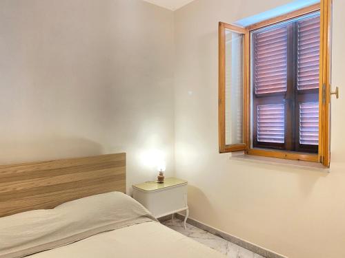 a bedroom with a bed and a window at Orlandi Sun casa 2 in Sarnano