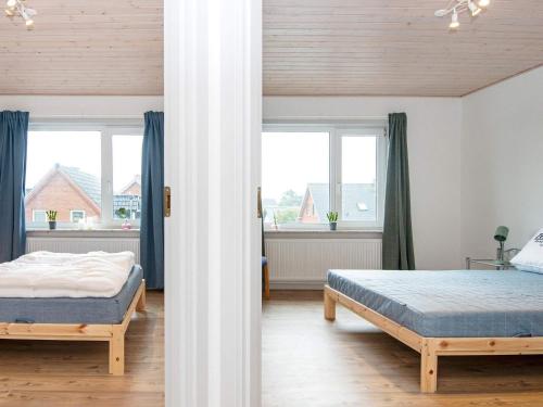 a bedroom with two beds and a window at 6 person holiday home in Harboøre-By Traum in Harboør