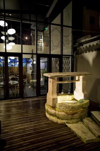 a stone table in the middle of a room at Aux Terrasses in Tournus