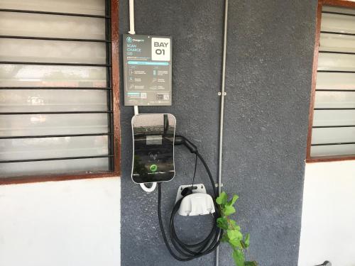 a pay phone is attached to a wall at Ipoh Family Homestay Masjid Muhammadiah Evicharger SY16 in Ipoh