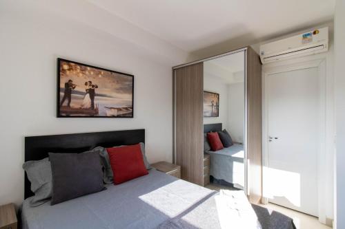 a bedroom with a bed and a large mirror at Sunset Studio - GRU in Guarulhos