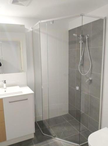 a bathroom with a shower with a glass door at Location, location, location - spacious apartment in Brisbane