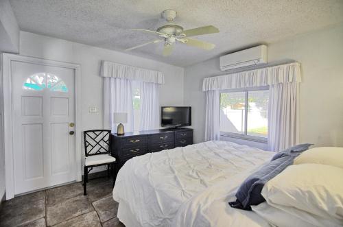 a bedroom with a bed and a ceiling fan at Gulfside Resort Unit 4 in St. Pete Beach