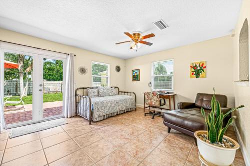 a living room with a couch and a ceiling fan at Beautiful Home Away From Home in Royal Palm Beach