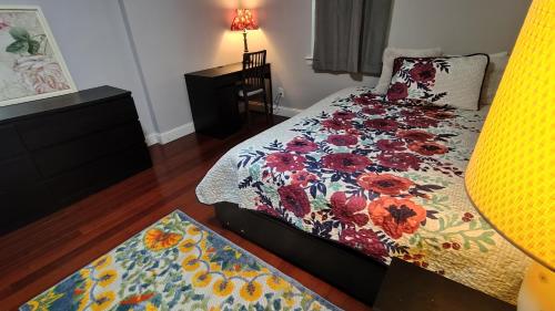 a bedroom with a bed with a floral comforter at Fairmount House in Philadelphia