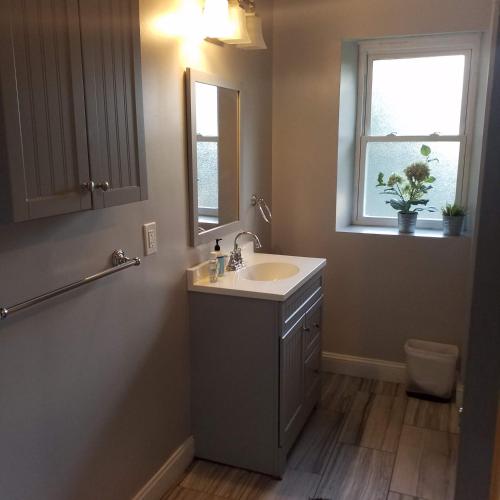a bathroom with a sink and a mirror and a window at Fairmount House Free Street Parking Quiet Spacious in Philadelphia