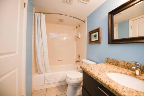 a bathroom with a sink and a toilet and a mirror at Welcome to the Pelican Lodge ! in Tavernier