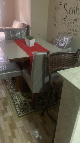 a dining room table and chairs with a table and a couch at Casa no bairro Heliópolis in Garanhuns