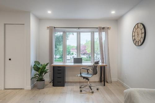 an office with a desk and a chair in front of a window at FREE PARKING PRIME LOCATION NEW MODERN CONDO in Brossard