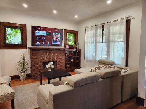 a living room with a couch and a fireplace at Classic Home in Niagara Falls