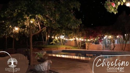 a park lit up at night with lights at CHOCLINO ECOLODGE -Bungalows in Tarapoto