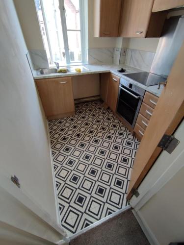 a small kitchen with a sink and a stove at Apartment in London in London