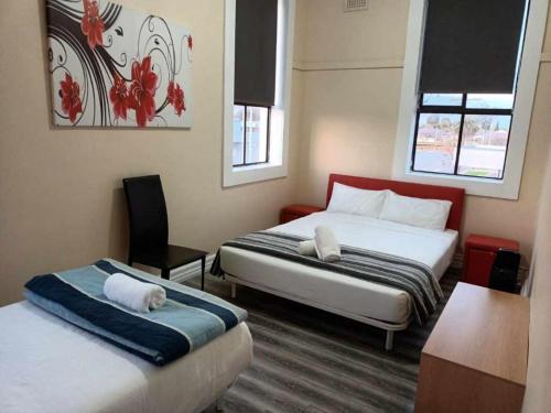 a hotel room with two beds and a desk at Albion Motel Finley in Finley