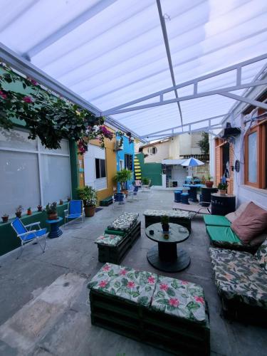 a patio with couches and a table in a building at Nomads Hostel Multicultural & Coworking in Salvador