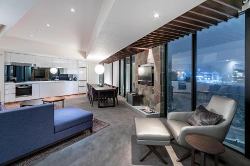 a living room with a couch and a dining room at The Vale Niseko in Niseko