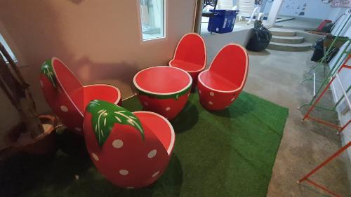 a group of red chairs sitting in a room at Family POOL VILLA CHAAM in Cha Am