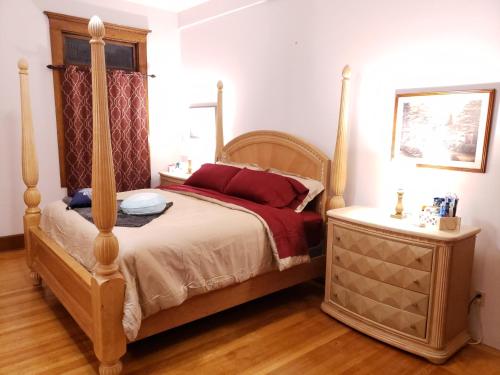 a bedroom with a four poster bed and a night stand at Beatrice The Villa in Marion