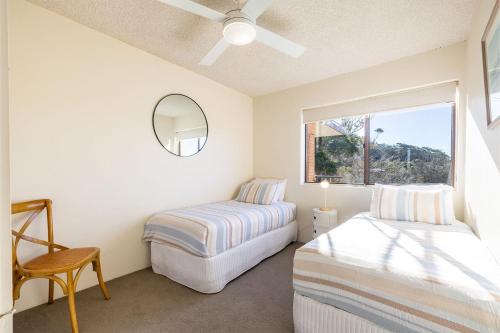 a bedroom with two beds and a window at Intrepid, 15 3 Intrepid Close - right on the beachfront and WiFi in Shoal Bay