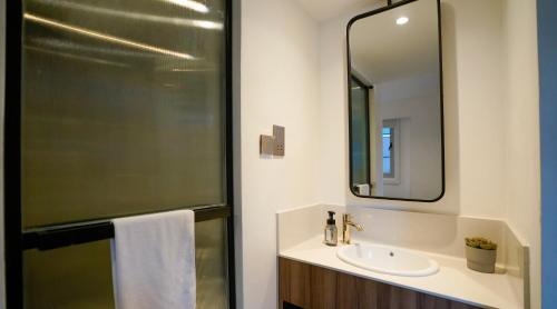 a bathroom with a sink and a mirror at ST Signature Bugis Middle in Singapore