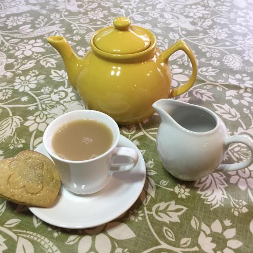a cup of tea and a teapot on a table at Forse of Nature in Latheron