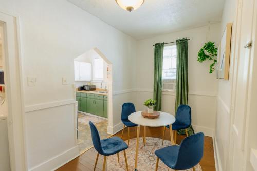 a dining room with blue chairs and a table at Historic Revival King Bed Midtown Memphis 70 Fast WiFi Free Parking Yes Pets in Memphis
