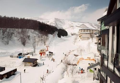 a group of people on a ski slope in the snow at The Vale Niseko in Kutchan
