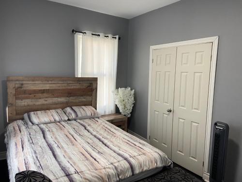 a bedroom with a bed and a white door at Oshawa Downtown, 2 Bed rooms house fully furnished in Oshawa